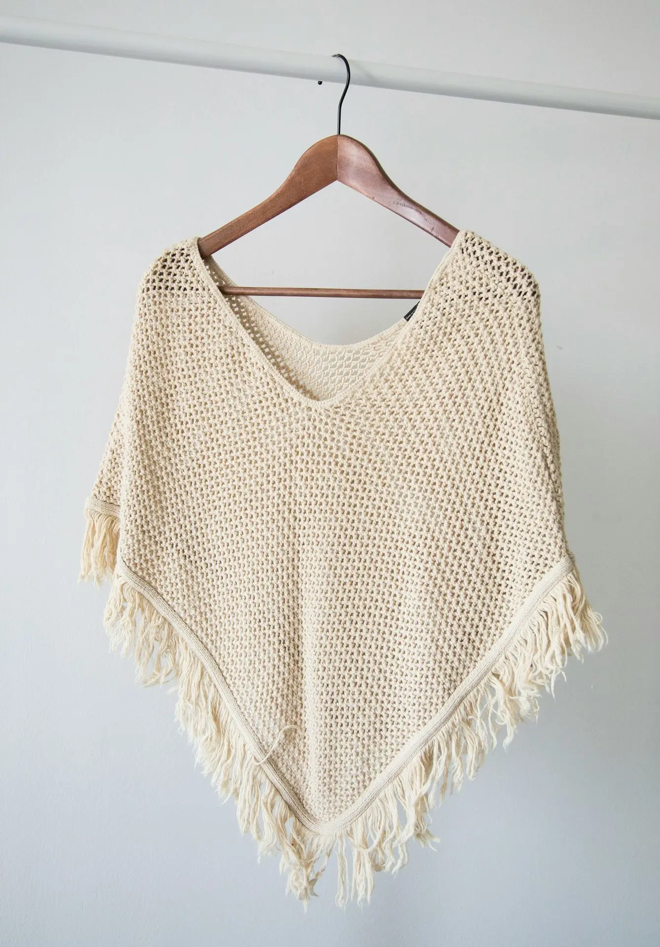 white v neck shirt on brown clothes hanger